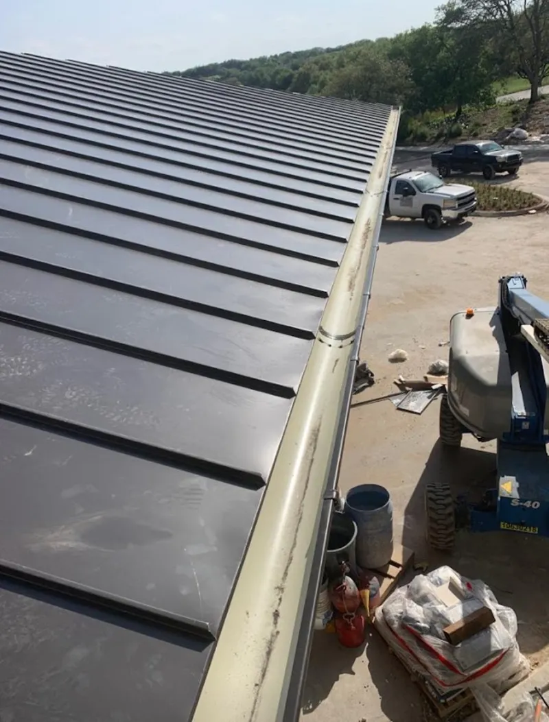 Standing seam panel and gutter detail on a metal roofing jobsite in Cameron Park
